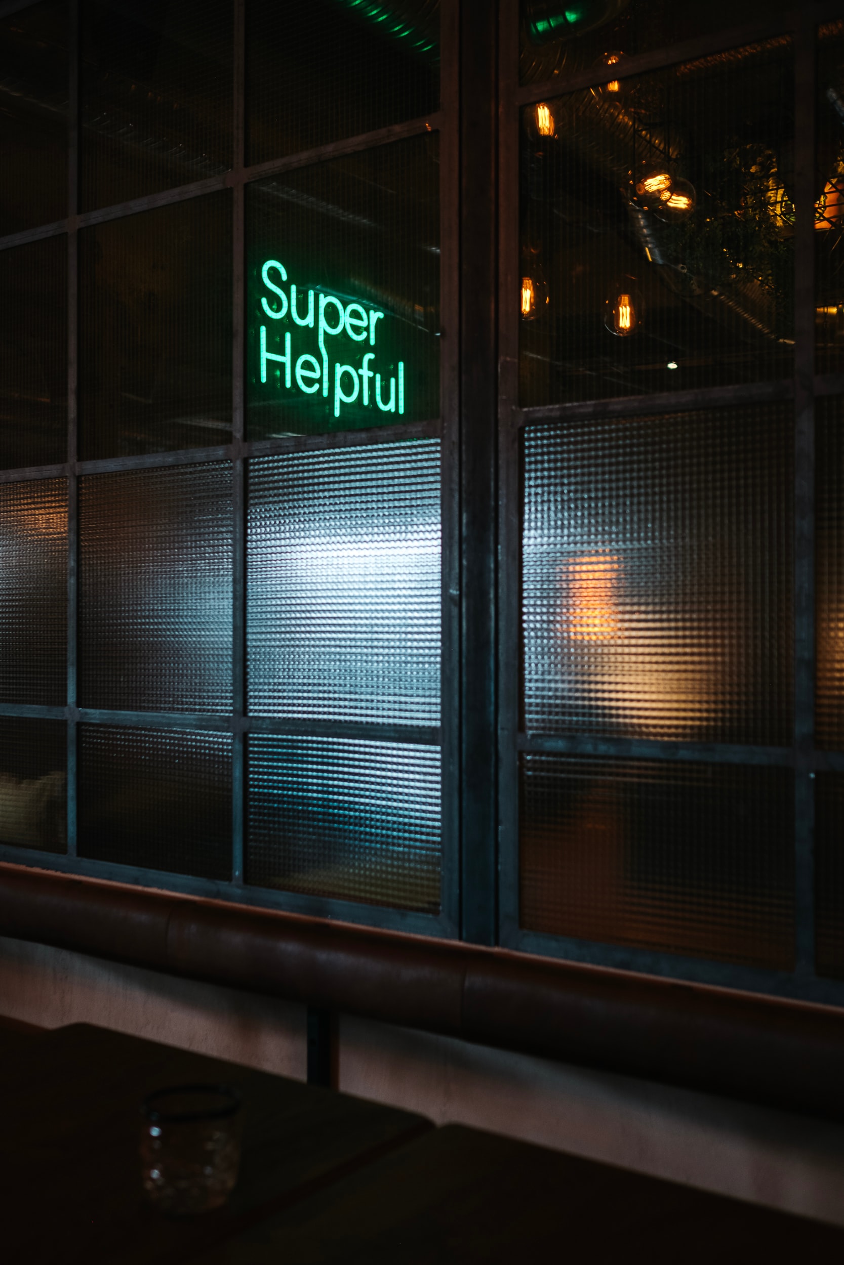 A neon sign that say 'super helpful'