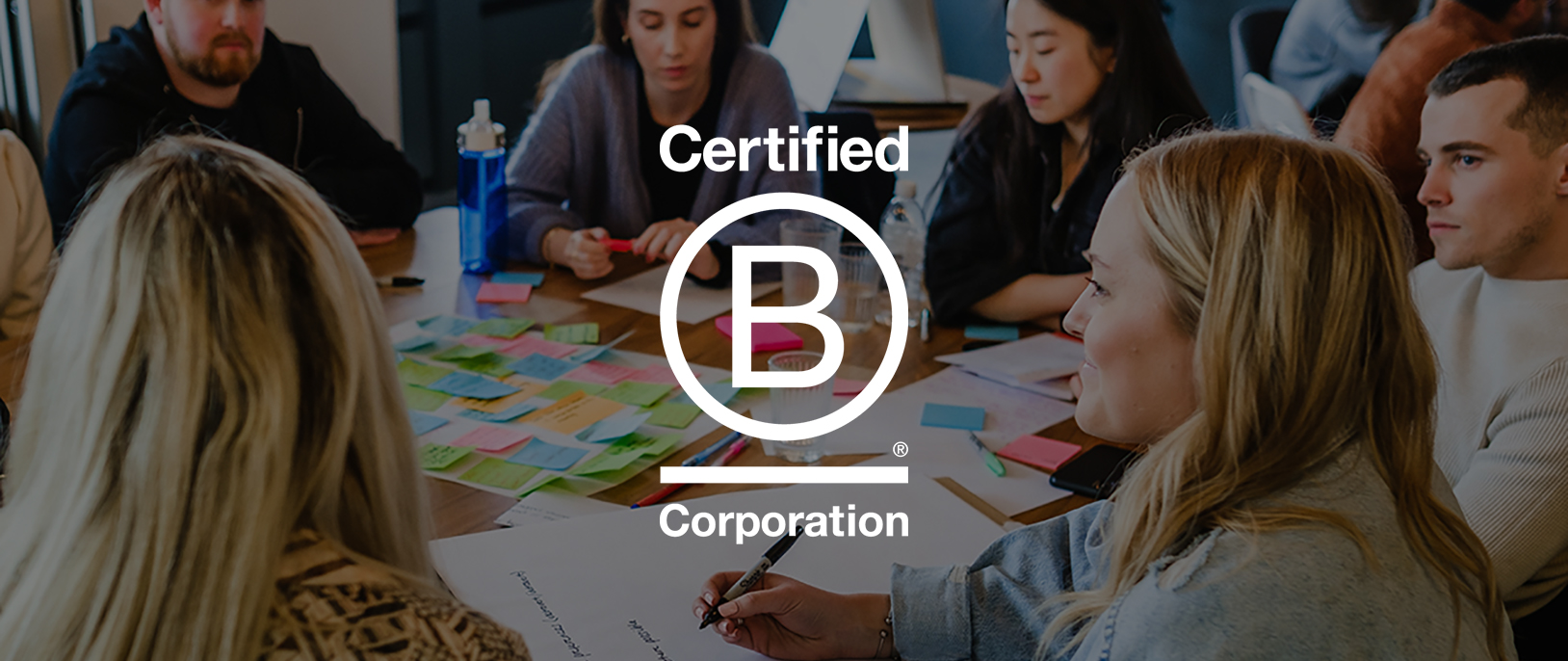 Graphite team members with white B Corp logo overlaid on top
