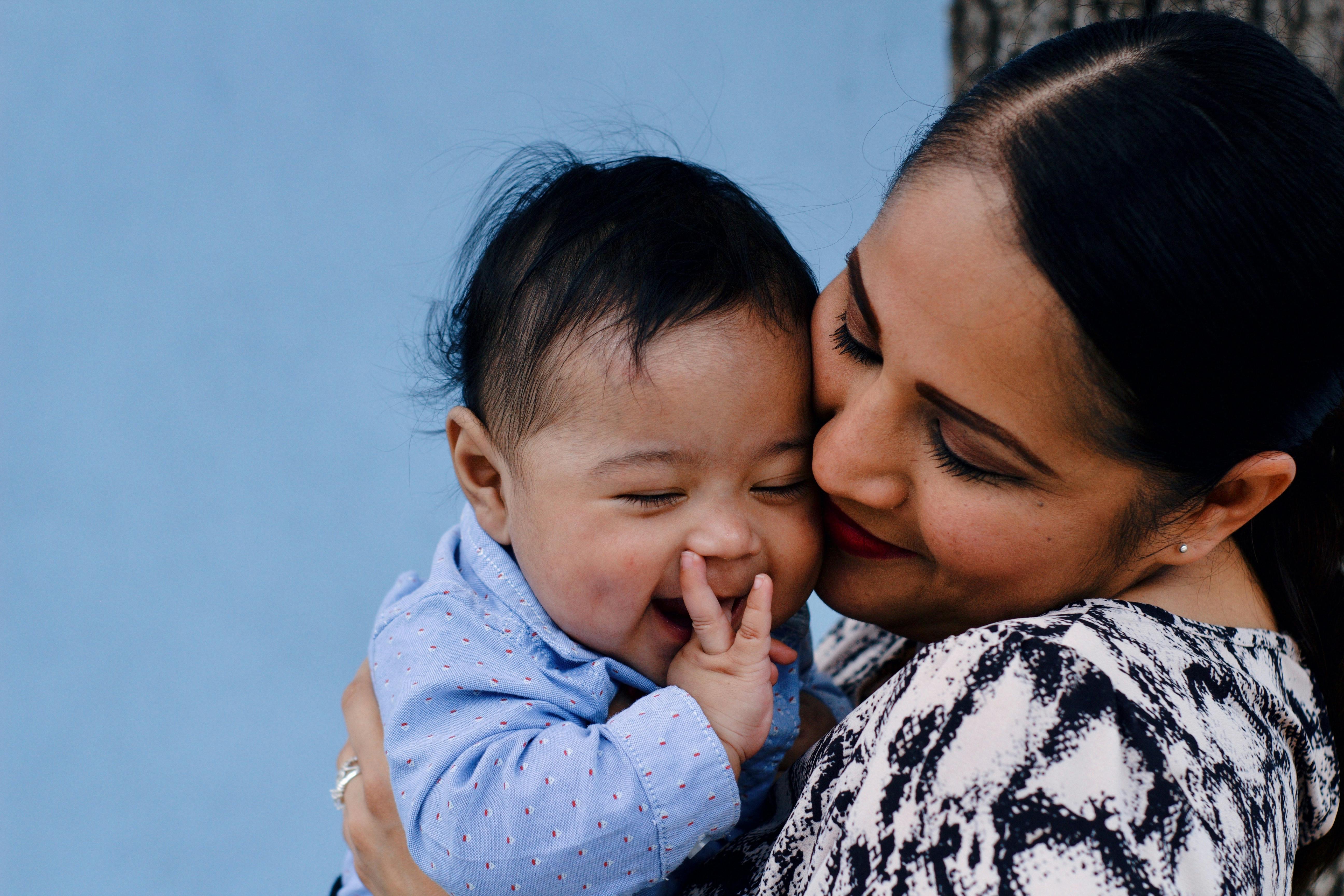 Woman holding and embracing a baby